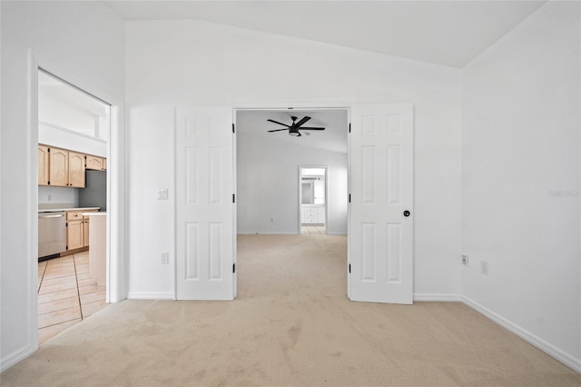 unfurnished room with lofted ceiling, light carpet, and ceiling fan