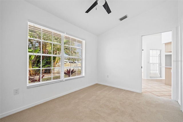 carpeted spare room with ceiling fan and lofted ceiling