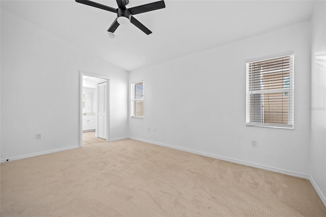 unfurnished room featuring ceiling fan, light carpet, and vaulted ceiling