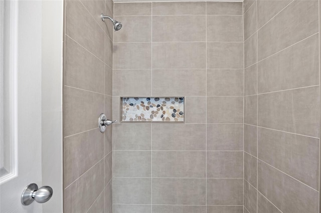 bathroom with a tile shower