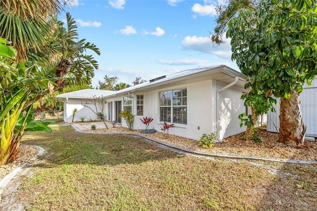 view of front of property with a front yard and a garage