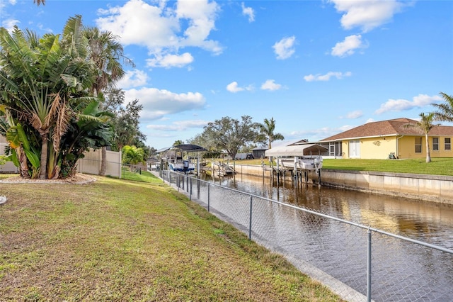 view of yard featuring a water view and a dock