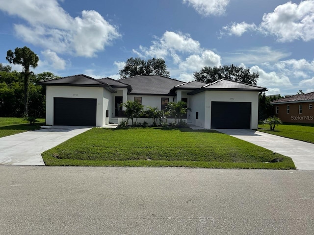 view of front of home with a garage and a front lawn