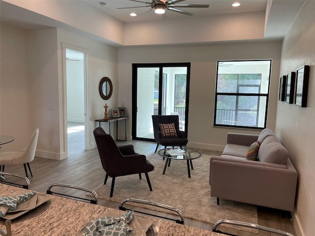 living room featuring ceiling fan and light hardwood / wood-style flooring