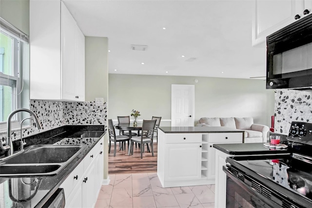 kitchen with backsplash, sink, white cabinets, and black appliances