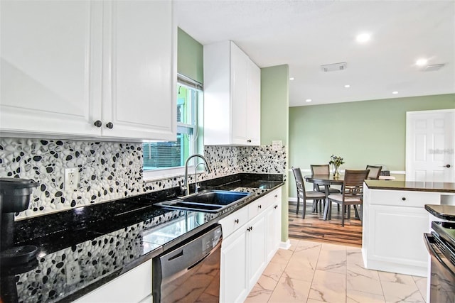 kitchen featuring dark stone countertops, white cabinetry, dishwasher, and sink