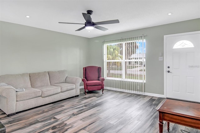 living room with ceiling fan and hardwood / wood-style floors