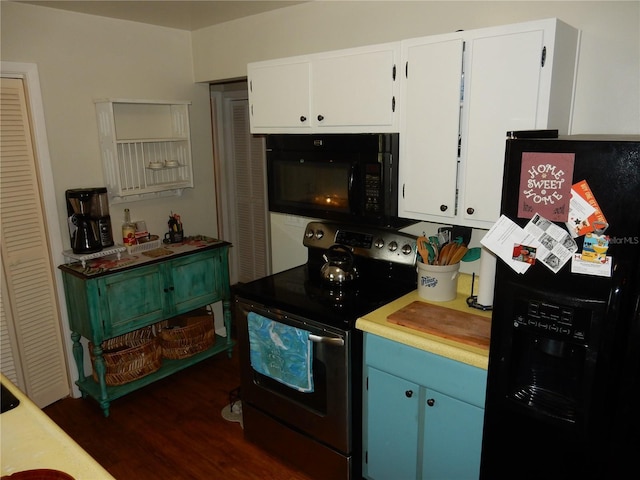 kitchen with white cabinets, black appliances, and dark hardwood / wood-style floors