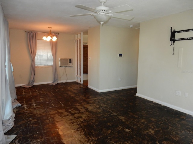 empty room with ceiling fan with notable chandelier, baseboards, and a wall mounted air conditioner