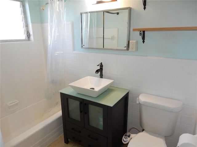 full bathroom featuring tile walls, shower / bathtub combination with curtain, toilet, wainscoting, and vanity