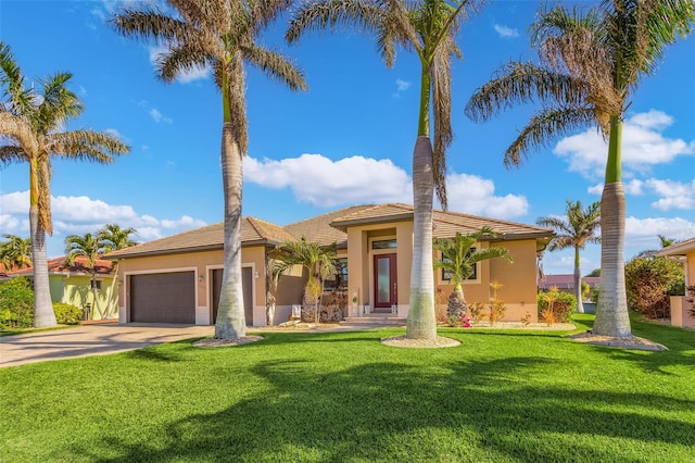 mediterranean / spanish home featuring a front lawn and a garage