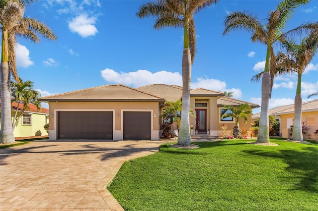 view of front facade with a front yard and a garage