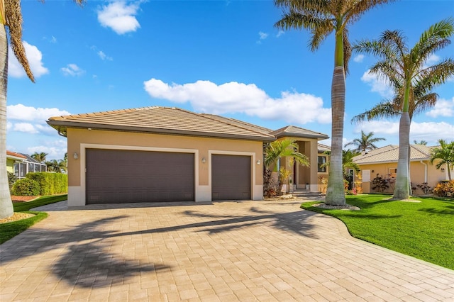 view of front of property with a front lawn and a garage