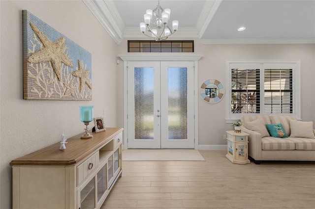 entryway featuring a wealth of natural light, french doors, crown molding, and a notable chandelier