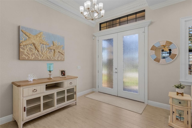 doorway to outside with ornamental molding, light hardwood / wood-style flooring, french doors, and an inviting chandelier