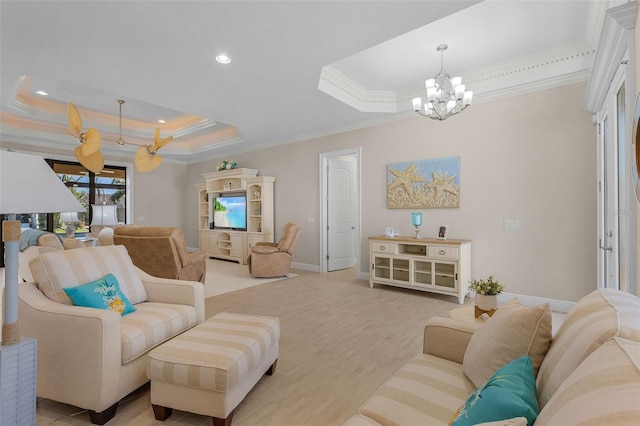 living room with a notable chandelier, light hardwood / wood-style flooring, ornamental molding, and a raised ceiling