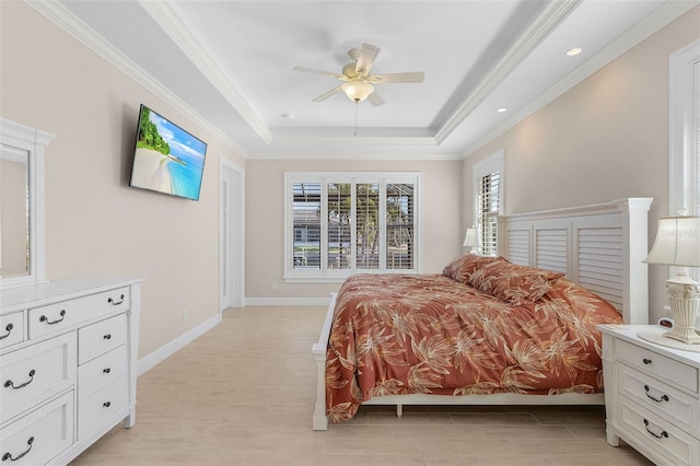 bedroom with ceiling fan, ornamental molding, and a raised ceiling