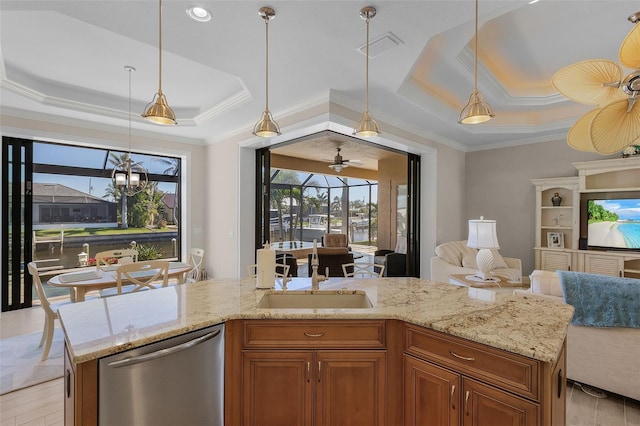 kitchen with light stone countertops, ornamental molding, a tray ceiling, sink, and stainless steel dishwasher