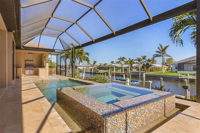 view of swimming pool featuring area for grilling, an in ground hot tub, glass enclosure, and a water view