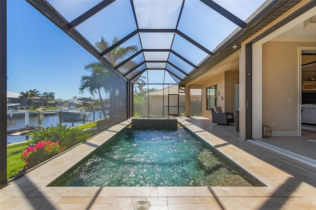 view of pool with a lanai, a patio, and a water view