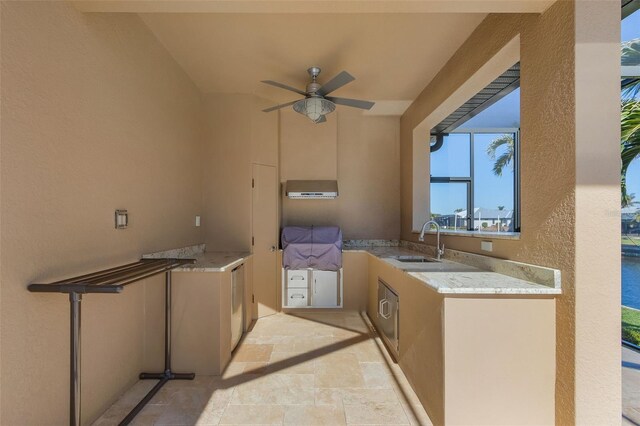 view of patio with exterior kitchen, ceiling fan, and sink