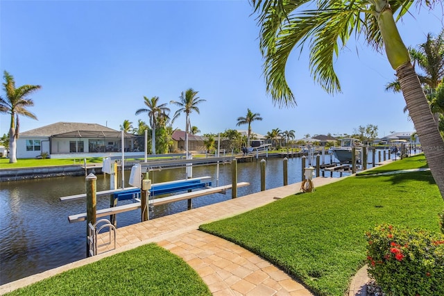 dock area featuring a water view and a lawn