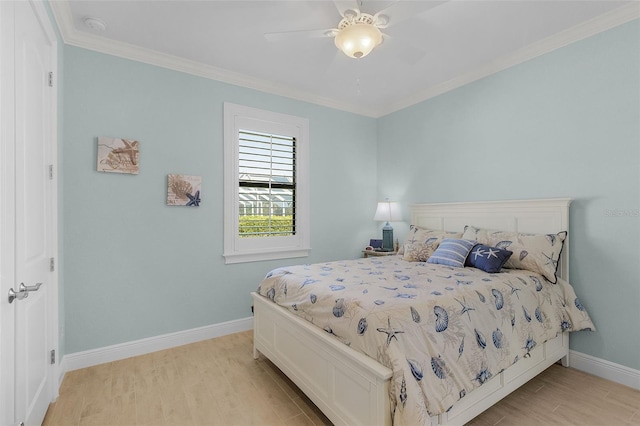 bedroom featuring light wood-type flooring, ceiling fan, and crown molding