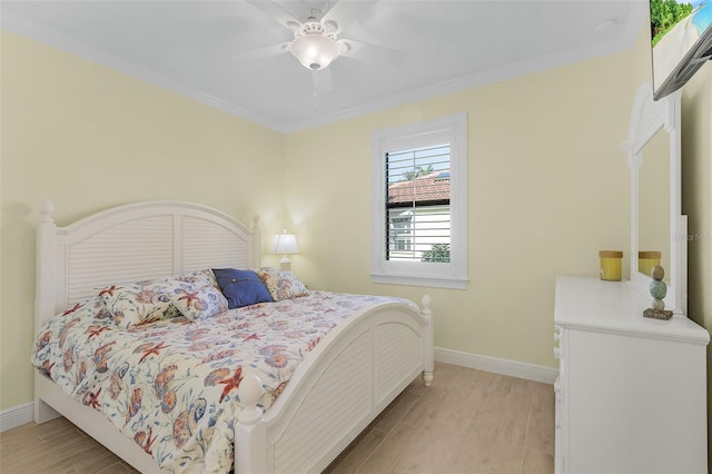 bedroom with ceiling fan, light wood-type flooring, and crown molding