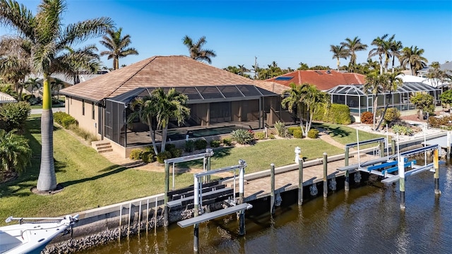 dock area with a lanai, a lawn, and a water view