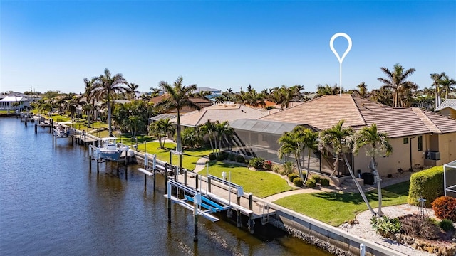 dock area with a lawn and a water view