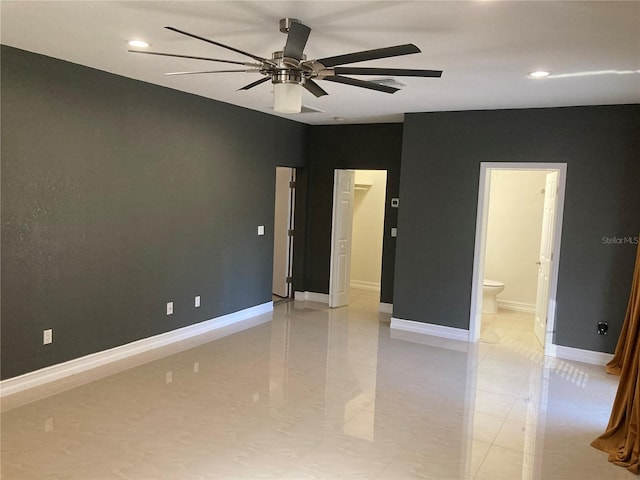 unfurnished bedroom featuring ceiling fan and ensuite bath