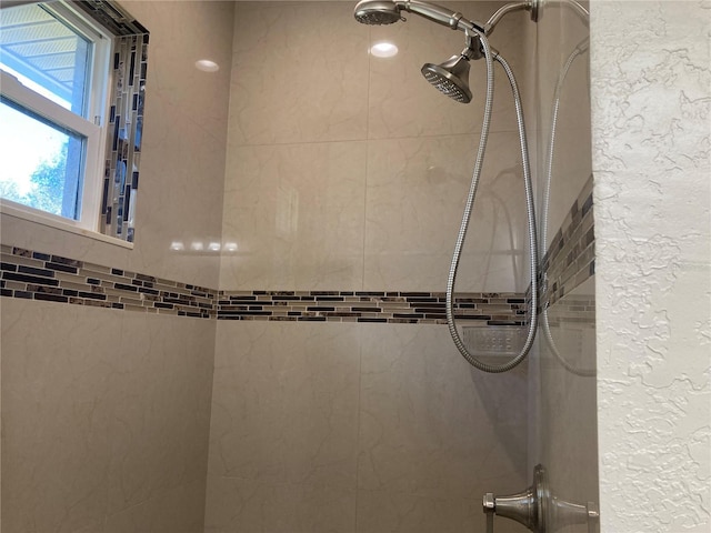 bathroom with tiled shower