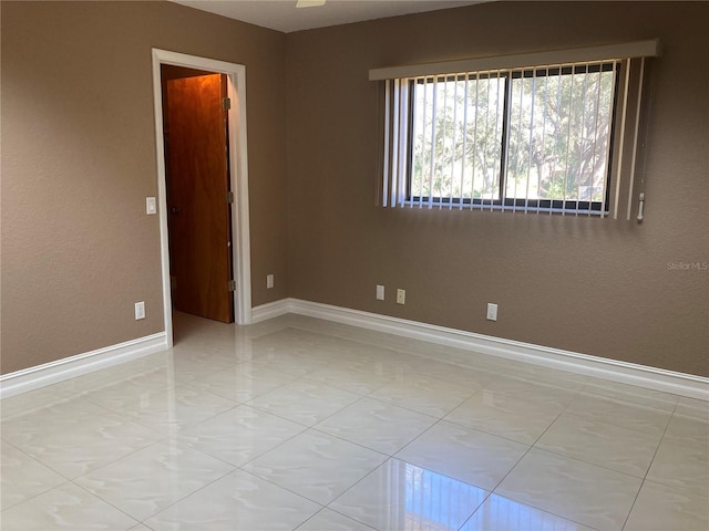 unfurnished room with light tile patterned floors