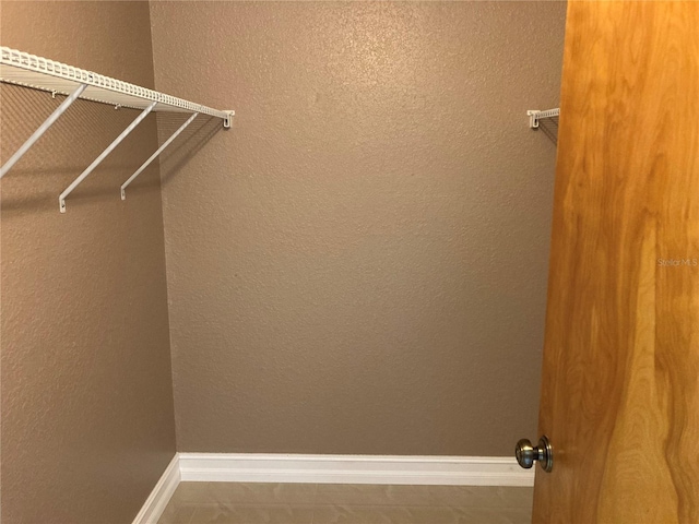 spacious closet featuring tile patterned flooring