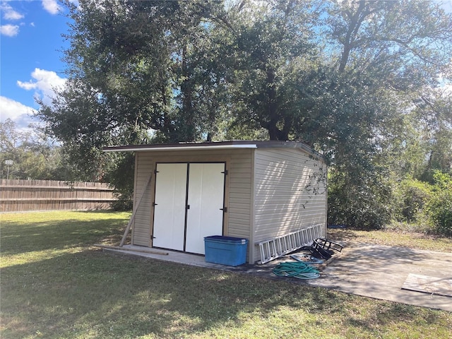 view of outbuilding featuring a lawn