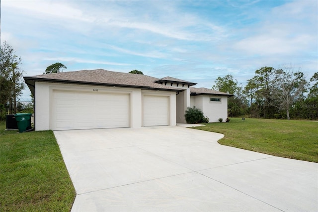 view of front of home with a front yard and a garage