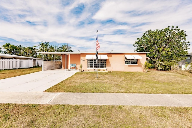 view of front of house with a front yard and a carport