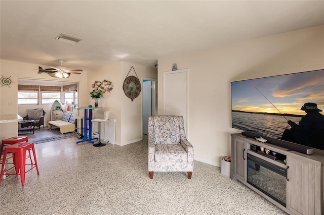 living area featuring ceiling fan