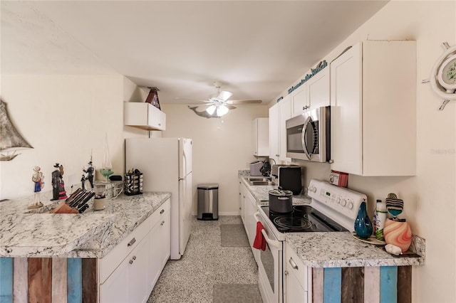 kitchen featuring ceiling fan, sink, white appliances, and white cabinetry