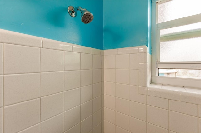 bathroom with tiled shower