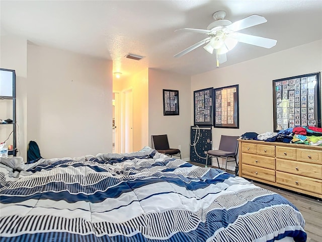 bedroom with wood-type flooring and ceiling fan