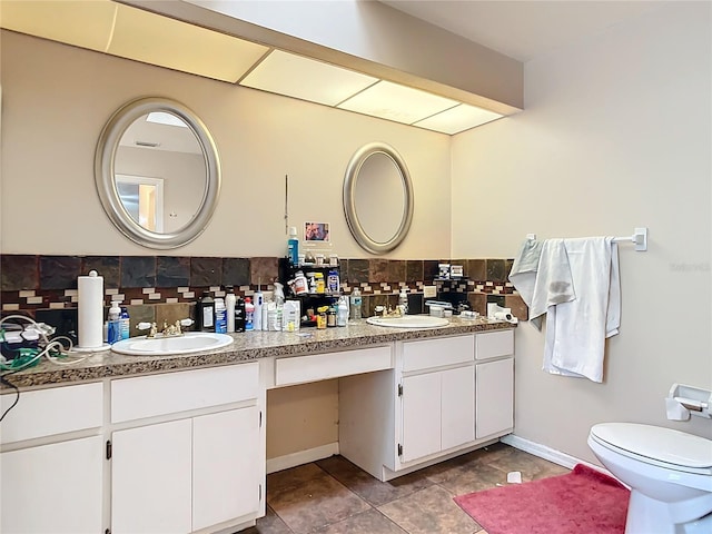 bathroom featuring vanity, backsplash, tile patterned flooring, and toilet