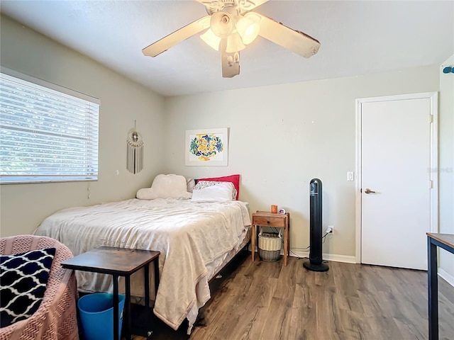 bedroom with hardwood / wood-style flooring and ceiling fan