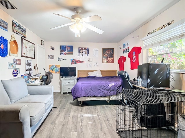 bedroom with hardwood / wood-style floors and ceiling fan