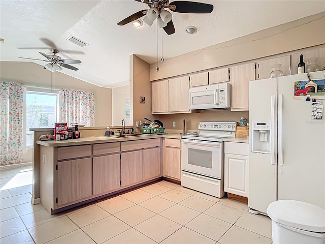 kitchen featuring light tile patterned flooring, light brown cabinetry, vaulted ceiling, kitchen peninsula, and white appliances