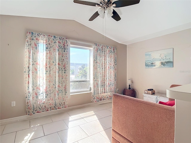 tiled living room with ceiling fan and lofted ceiling