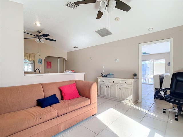 tiled living room featuring vaulted ceiling and ceiling fan