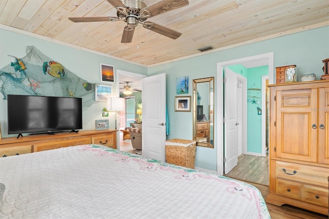 bedroom with ceiling fan, wood ceiling, crown molding, and hardwood / wood-style floors