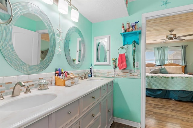 bathroom with ceiling fan, hardwood / wood-style floors, and vanity