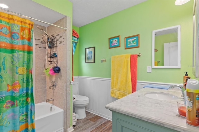 full bathroom featuring hardwood / wood-style flooring, toilet, vanity, and shower / bath combination with curtain